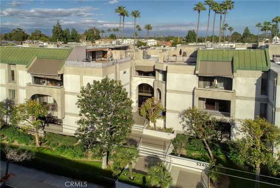 Front view of a multi-story apartment building with balconies.