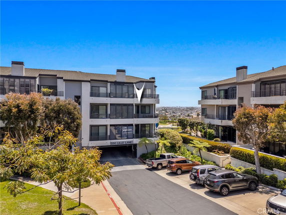 Front view of a multi-story residential building with balconies.