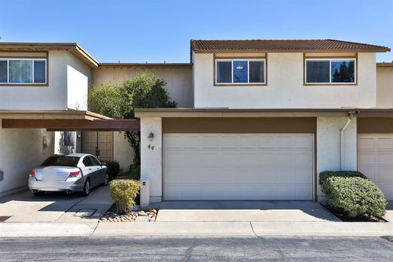 Front view of a two-story house with a double garage and covered parking.