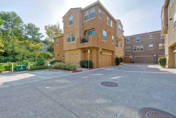 Front view of multi-story residential buildings with garages on the ground floor.