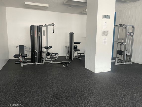 Indoor fitness area with exercise machines.