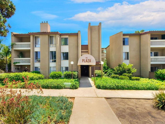 Front view of a multi-story residential building named 'The Plaza'.