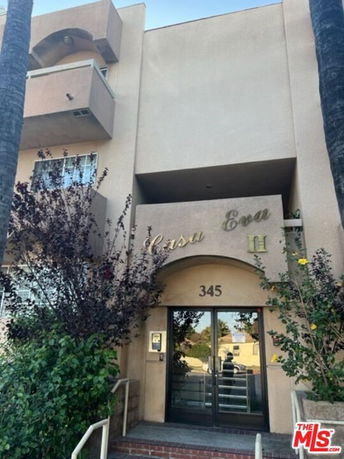 Front view of a multi-story apartment building with 'Casa Eva' signage.
