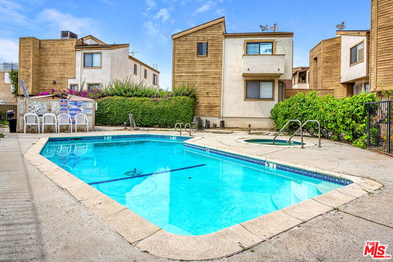 Swimming pool area with nearby residential buildings.