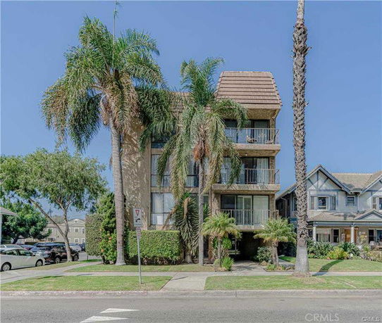 Front view of a multi-story building with balconies.