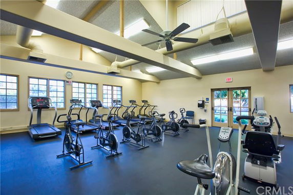 Indoor gym area with exercise bikes and treadmills.