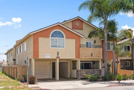 Front view of a two-story house with a garage.