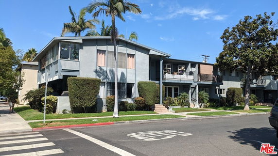 Front view of a two-story apartment building with balconies.