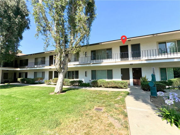 Front view of a two-story building with balconies.