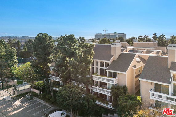 Aerial view of a complex with multiple gabled roofs and balconies.