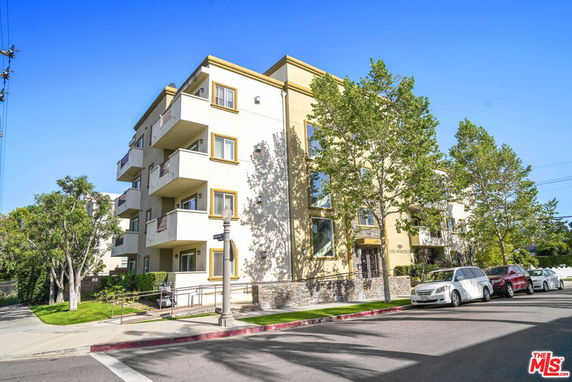 Front view of a multi-story apartment building with balconies.