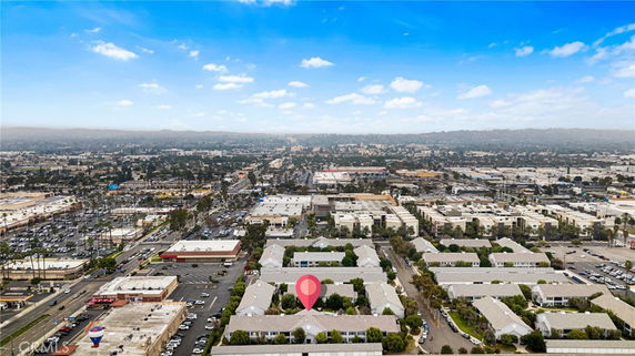 Wide aerial view of commercial and residential buildings in a cityscape.