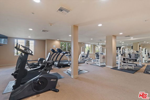 Indoor gym area with exercise machines and workout equipment.