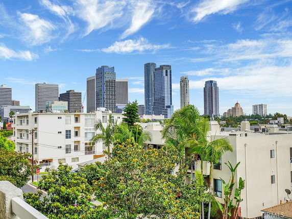 Panoramic view of a cityscape with multiple high-rise buildings.