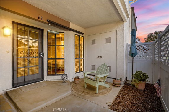 Front view of an entrance area with a seating arrangement and door.