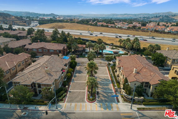 Panoramic view of residential buildings with a pool and surrounding area.