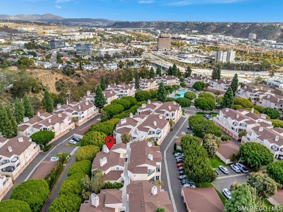 Aerial view of a residential area with multiple houses and trees.