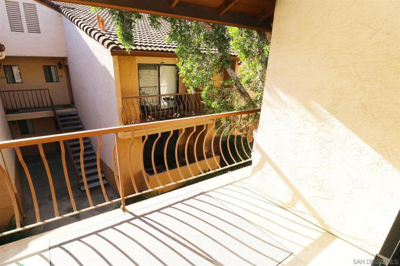 View from a balcony overlooking adjacent building corridors and staircases.