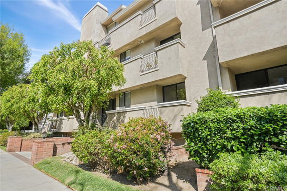 Front view of a multi-story residential building with balconies.