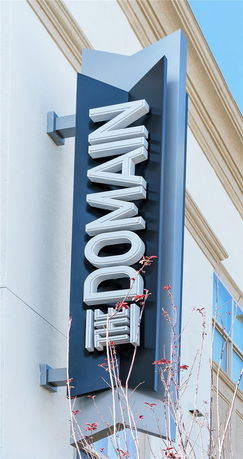 View of a building elevation with a vertical sign.