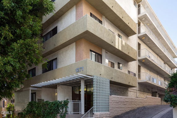 Front view of a multi-story residential building with balconies.