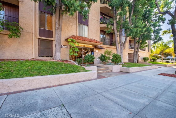 Front view of a multi-story apartment building with a central entrance.