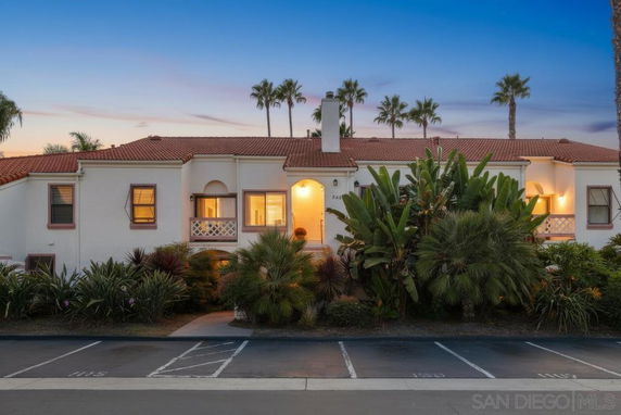 Front view of a two-story house with a tile roof and a central entrance.