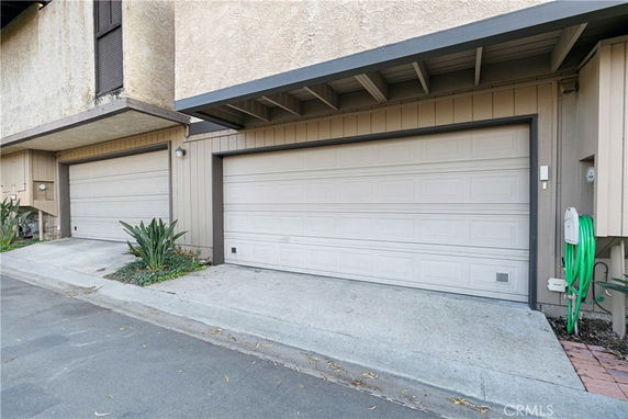 Two covered garage doors of a residential building.