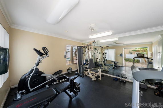 Gym area with exercise equipment like treadmill and weight machines.