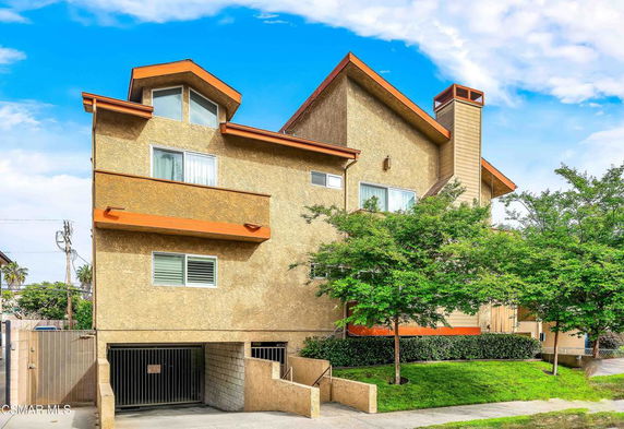 Front view of a multi-story house with a modern architectural design.