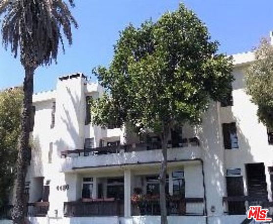 Front view of a multi-story building with balconies.