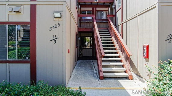 Entrance view of a multi-level building with external stairway access.