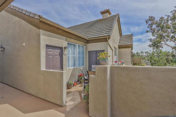 Front view of a house with a small outdoor patio area.