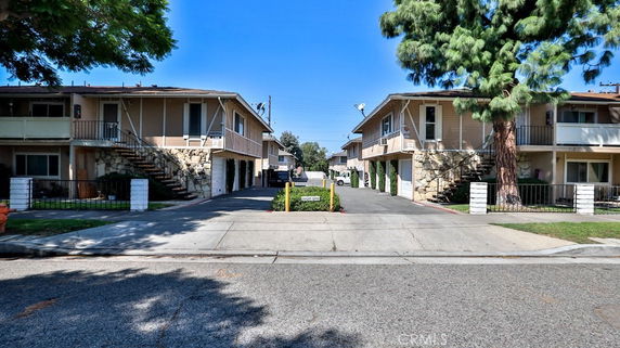 Front view of two-story residential buildings with exterior stairs and balconies.