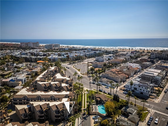Panoramic view of a coastal cityscape with several residential buildings near the ocean.