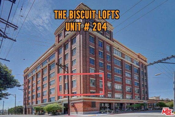 Front view of a multi-story red brick loft building called The Biscuit Lofts.