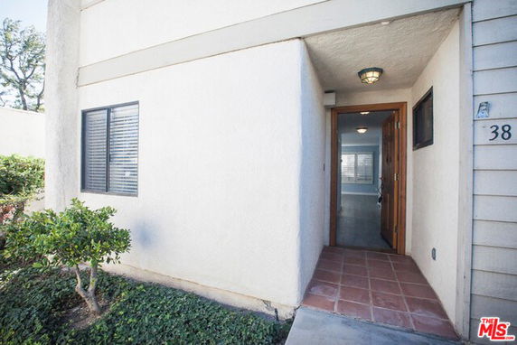 Entrance view of a residential building with a recessed entryway.