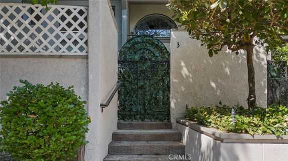 Front view of a house with a decorative gate and exterior staircase.