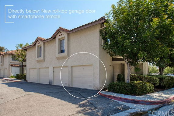 Front view of a multi-story house with garages beneath.