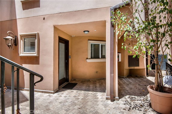 Front view of a residence with a small entrance area and tiled flooring.