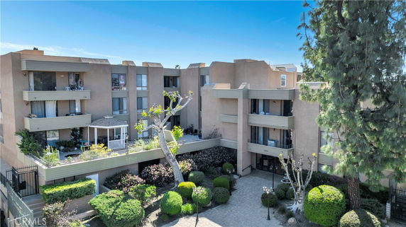 Front view of a multi-story apartment building with balconies.