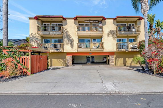 Front view of a multi-story building with balconies.