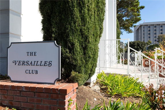 Entrance view with signage for The Versailles Club.
