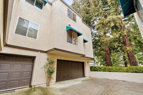 Front view of a two-story house with dual garages and simple modern design.