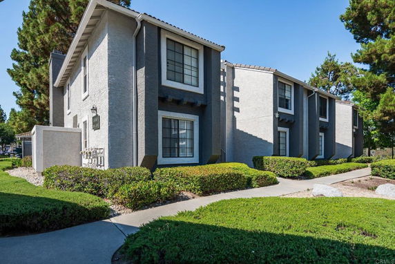 Front view of a two-story residential building with distinctive architectural design.