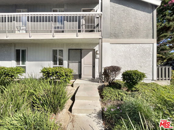 Front view of a two-story house with a balcony.