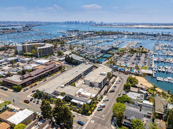 Panoramic view of a marina with numerous boats and surrounding buildings.