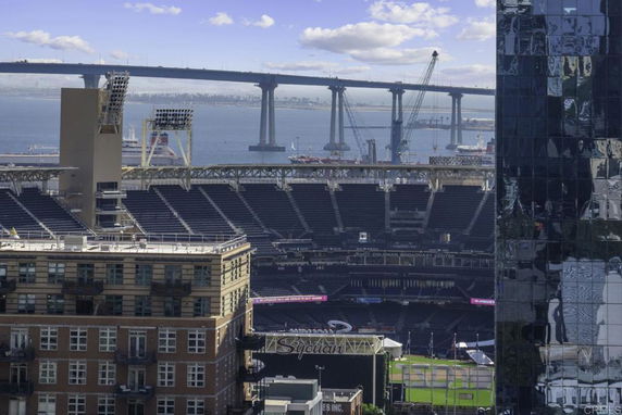 Aerial view of a stadium and a bridge over water.