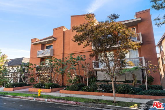 Front view of a multi-story building with balconies.