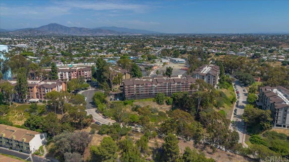 Aerial view of a residential area with multiple apartment buildings and surrounding greenery.